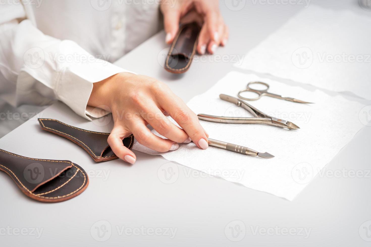 Manicurist lays out manicure set photo