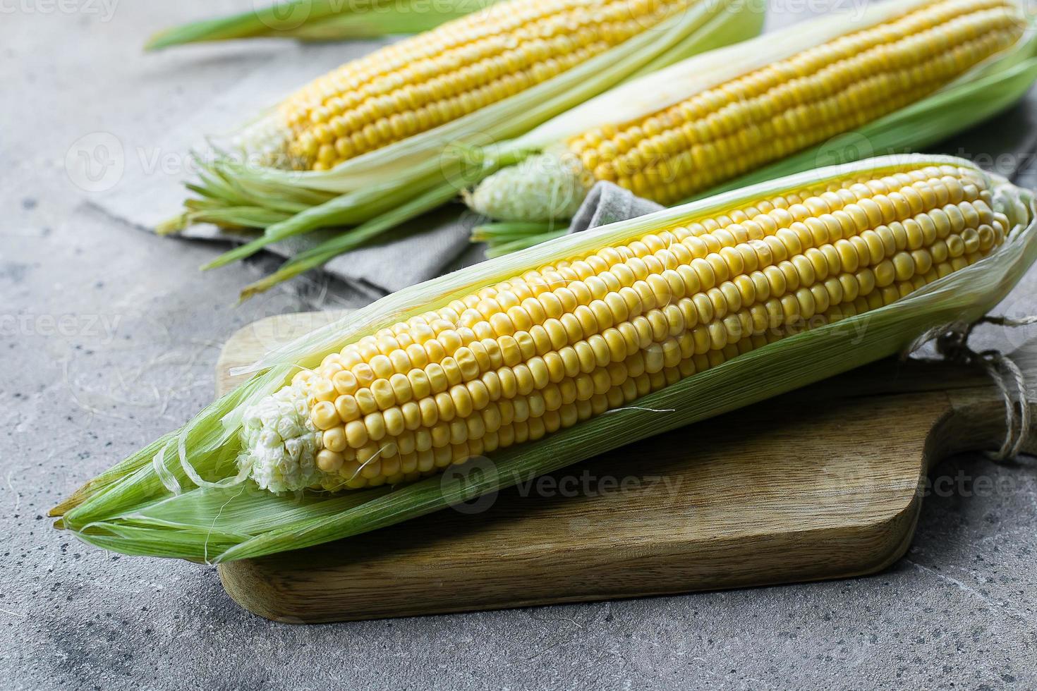 Fresh corn on cobs in a tissue bag. Zero waste concept. Close-up. photo