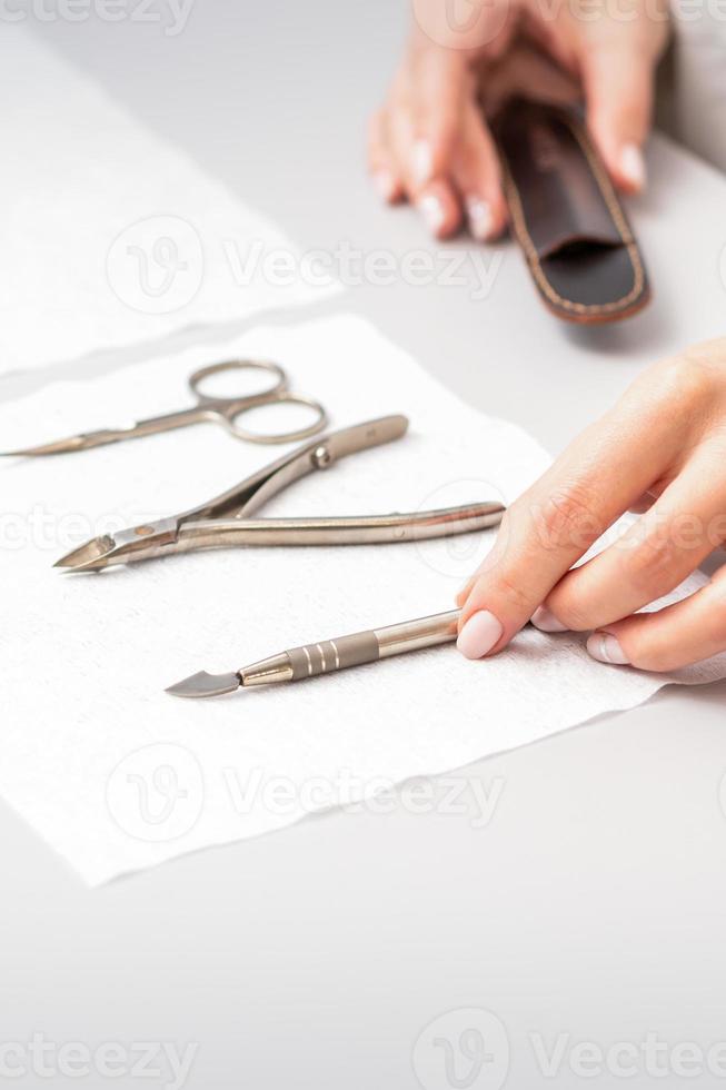 Manicurist lays out manicure set photo