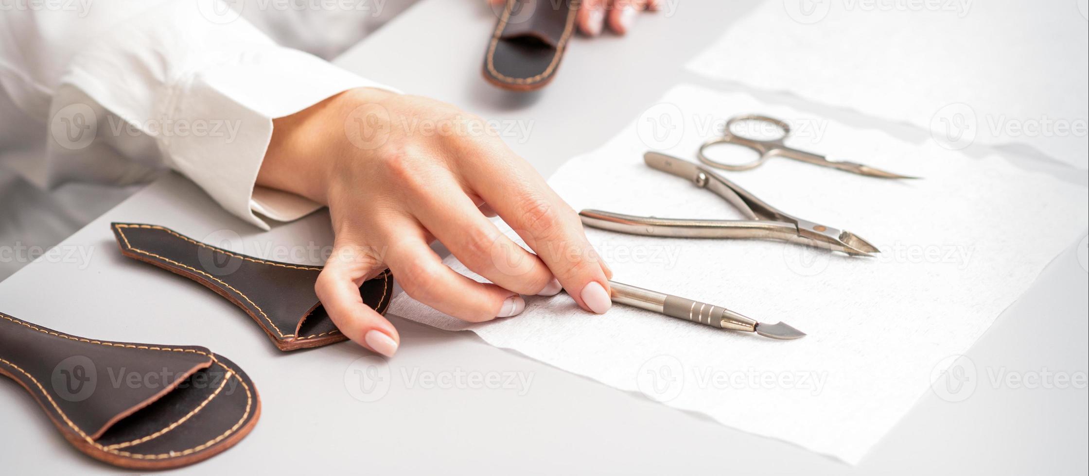 Manicurist lays out manicure set photo