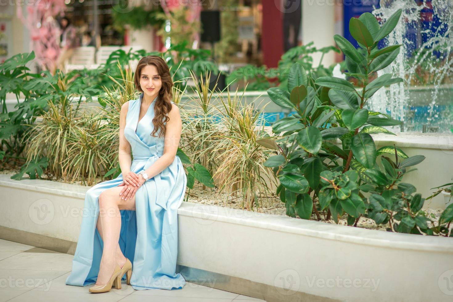 Woman sitting in flower garden photo