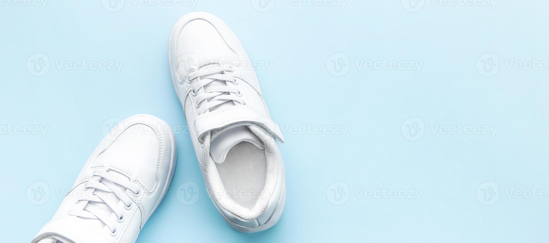 White sneakers on a blue background. photo