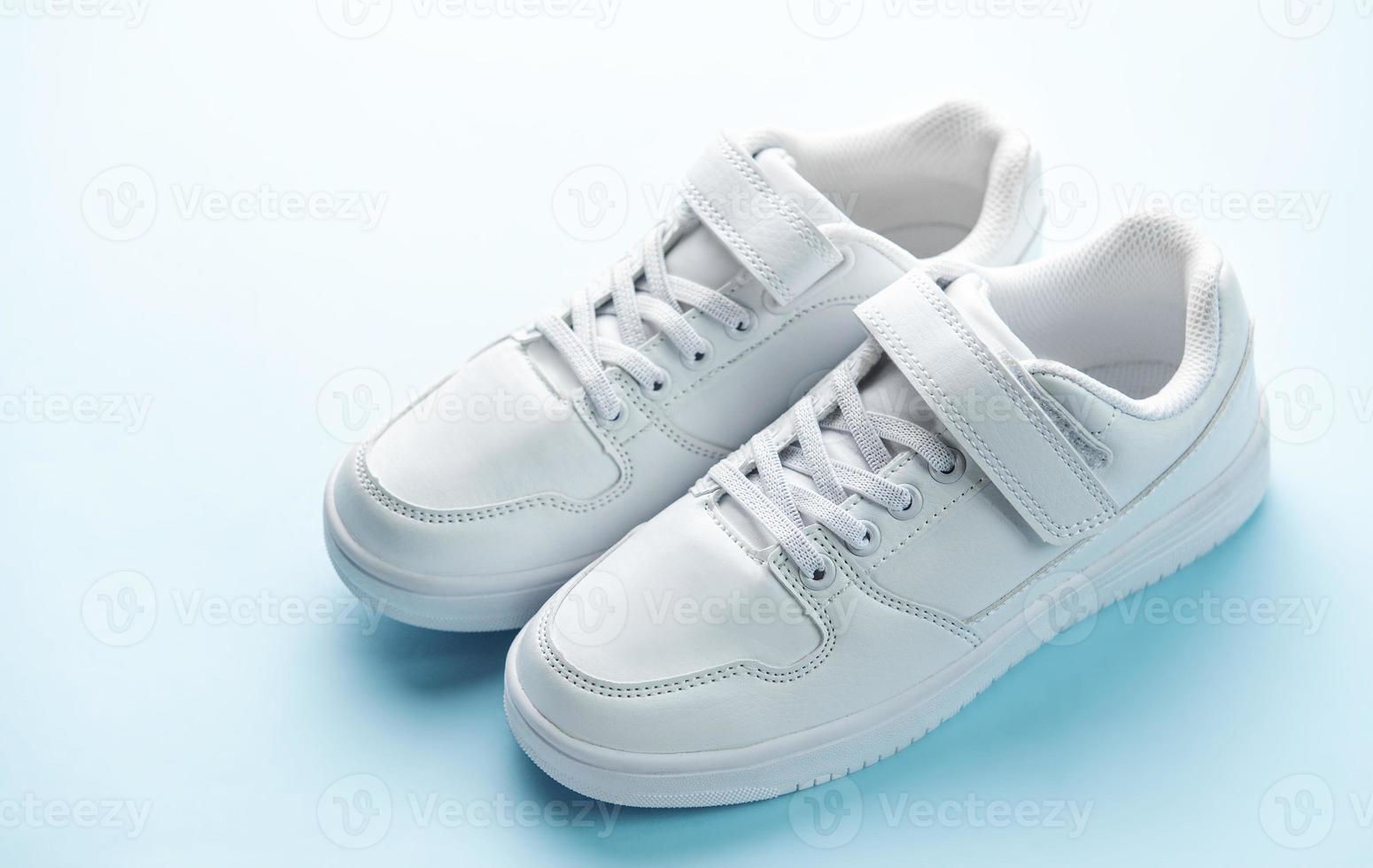 White sneakers on a blue background. photo