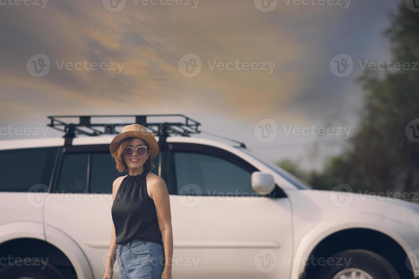 beautiful woman standing in front of suv car with toothy smiling happiness face photo