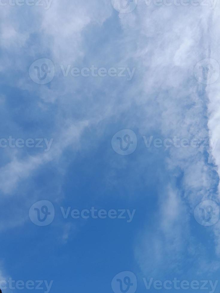 Beautiful white clouds on deep blue sky background. Large bright soft fluffy clouds are cover the entire blue sky. photo