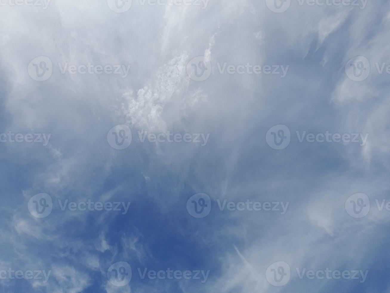 Beautiful white clouds on deep blue sky background. Large bright soft fluffy clouds are cover the entire blue sky. photo