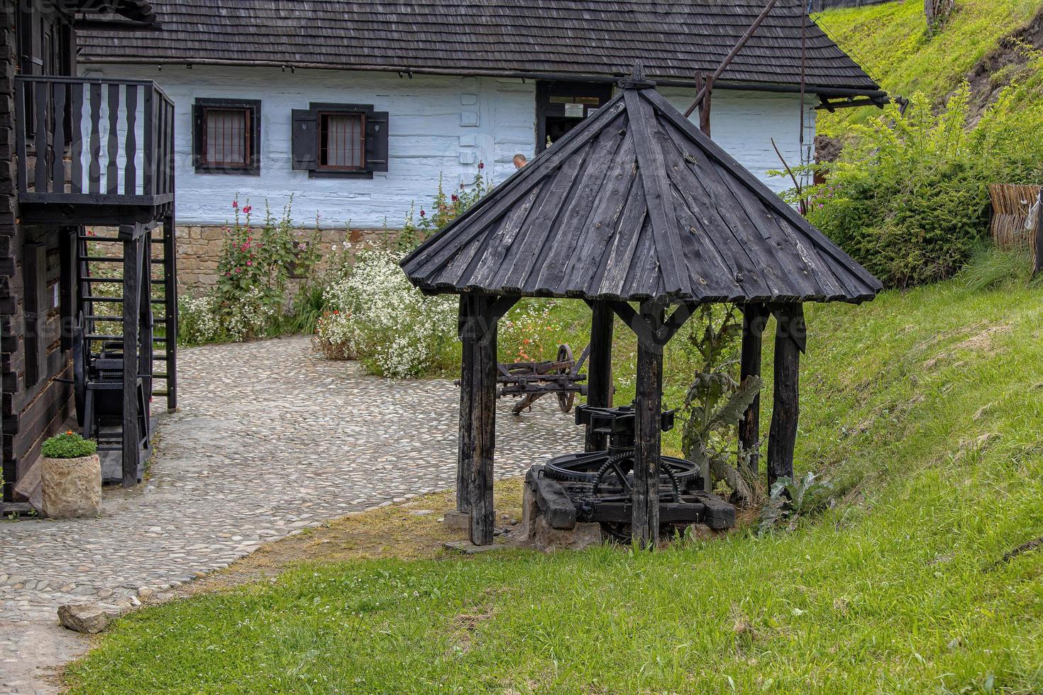 historic wooden rural buildings with an open-air museum in Dobczyce Polish mountains on a summer day photo