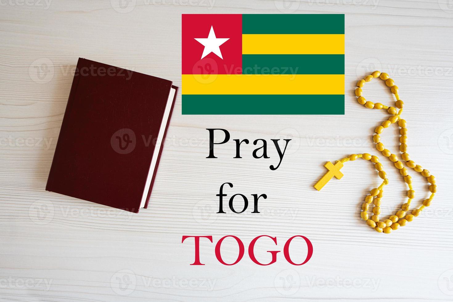 Pray for Togo. Rosary and Holy Bible background. photo