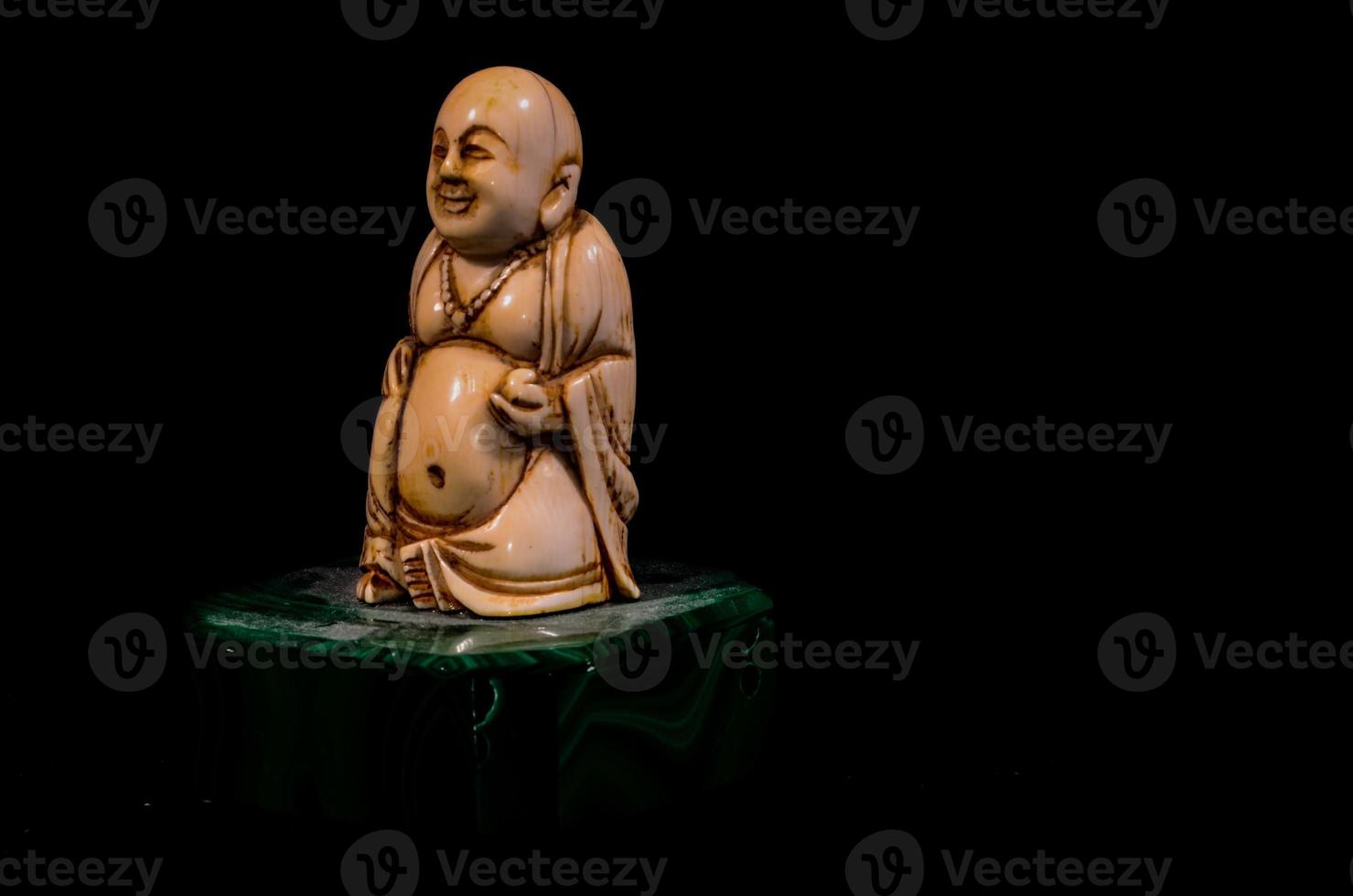 Buddha sculpture on black background photo