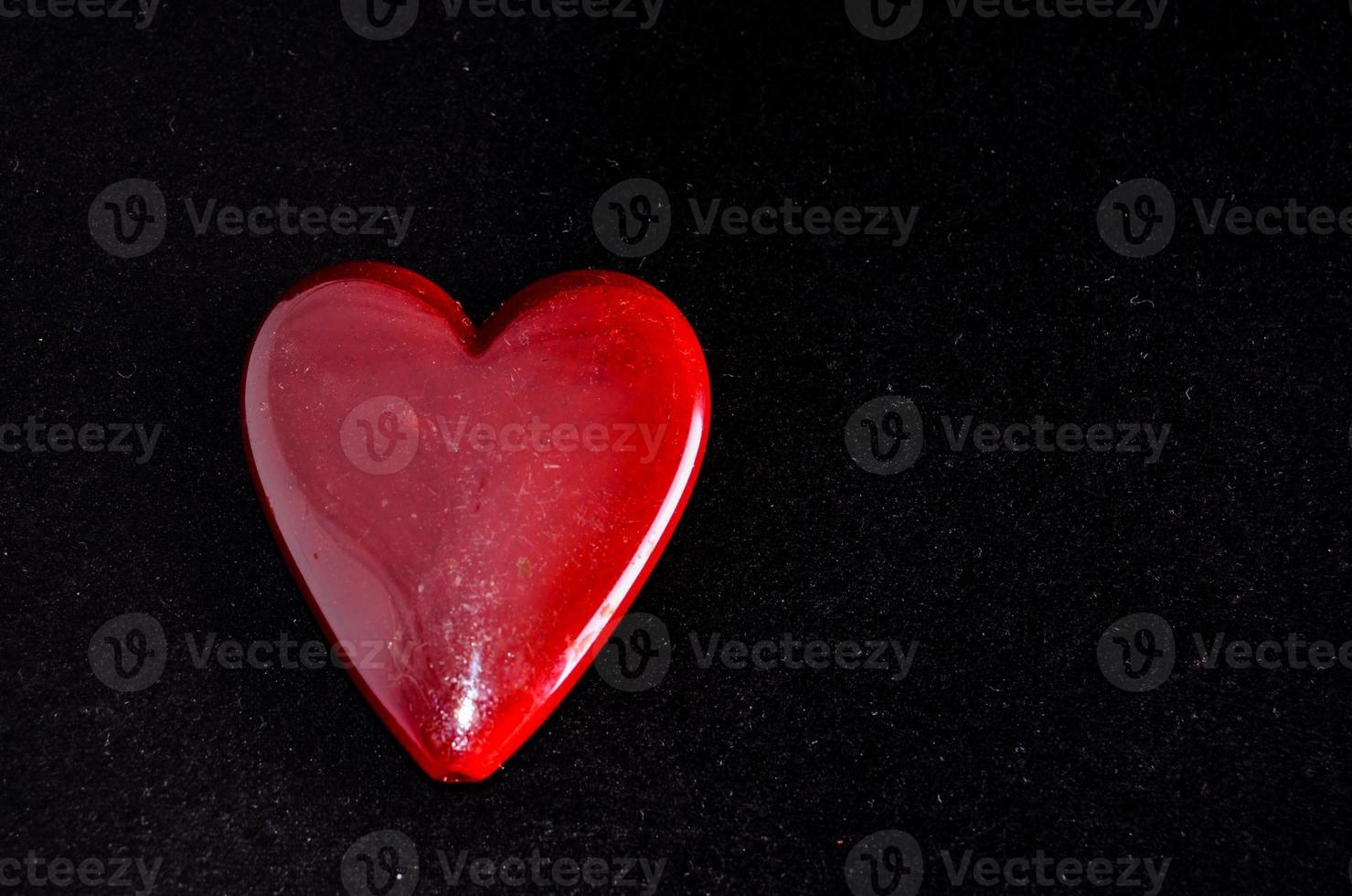 A red heart on black background photo