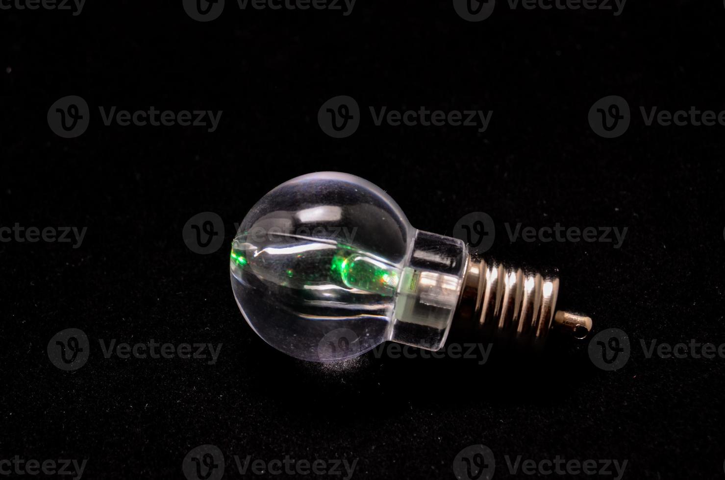 A lightbulb on black background photo