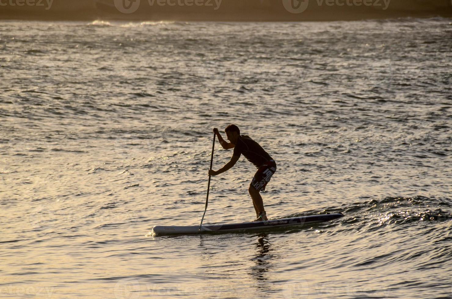 The silhouette of a man against the background of the sea photo