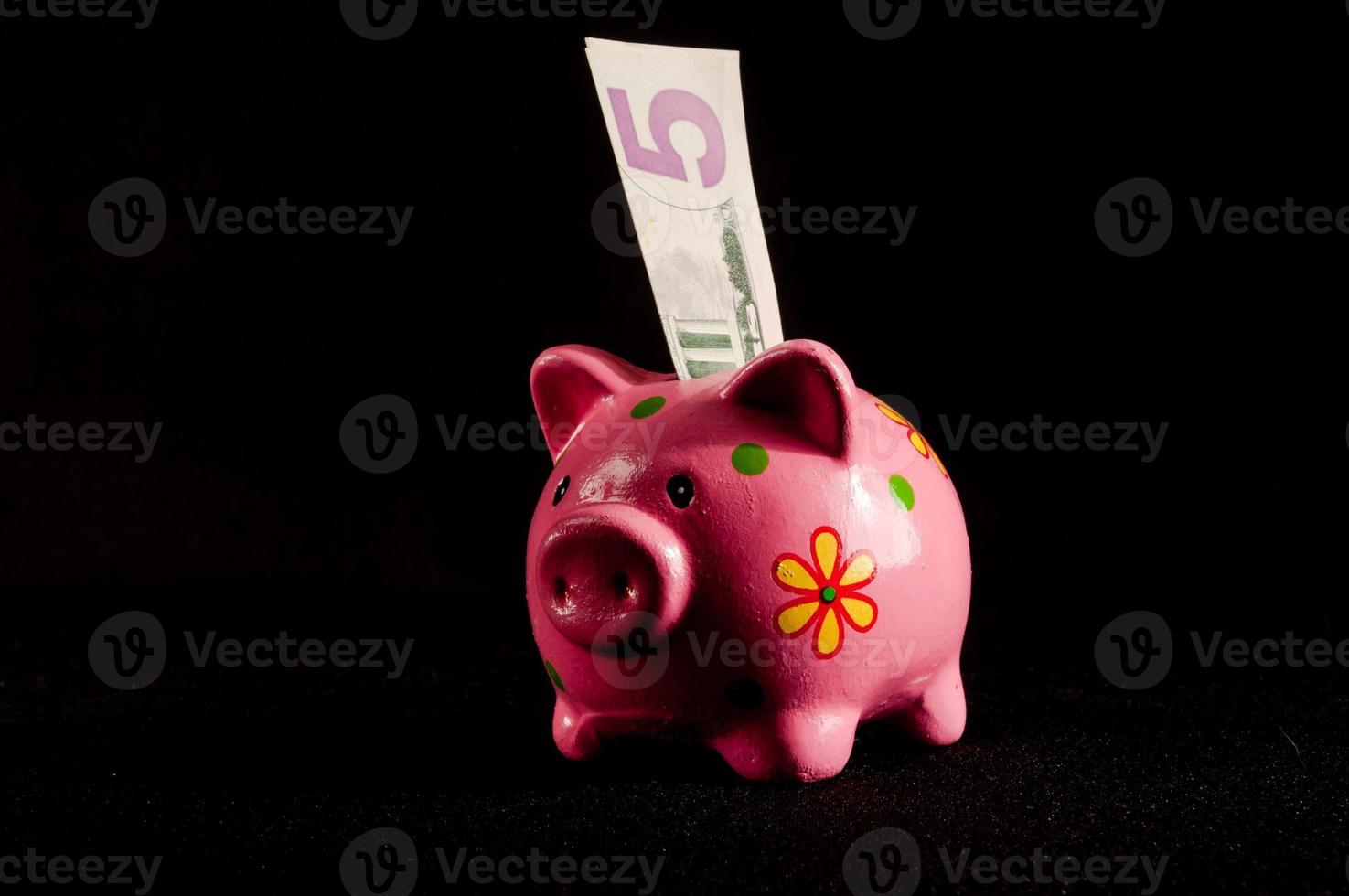 Piggy bank on black background photo