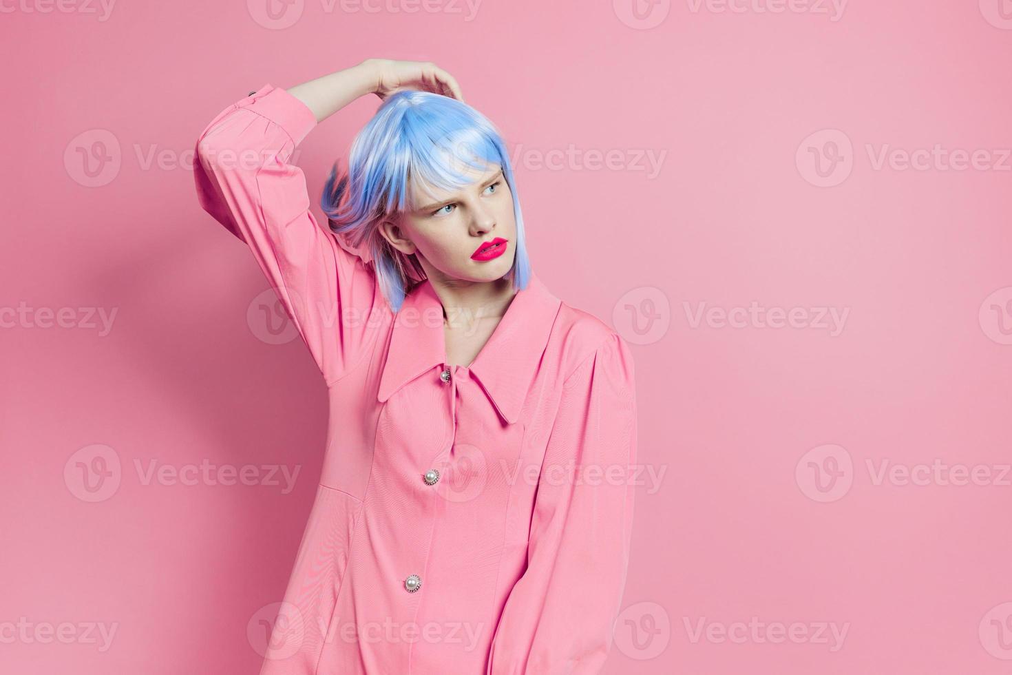 fashionable woman in blue wig pink dress red lips studio model photo