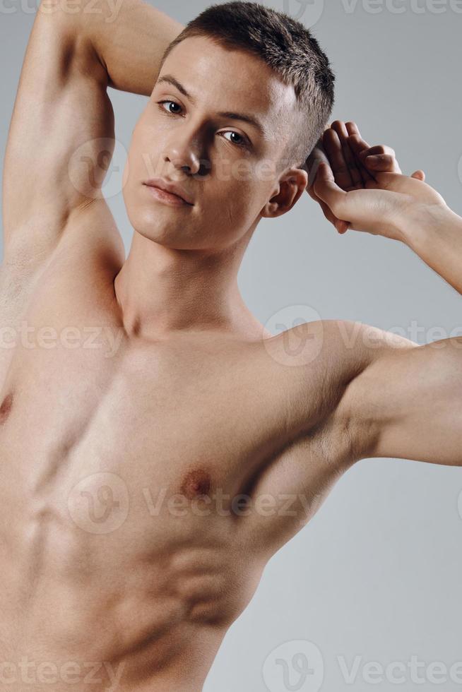 athletic physique young male nude torso gray background portrait photo