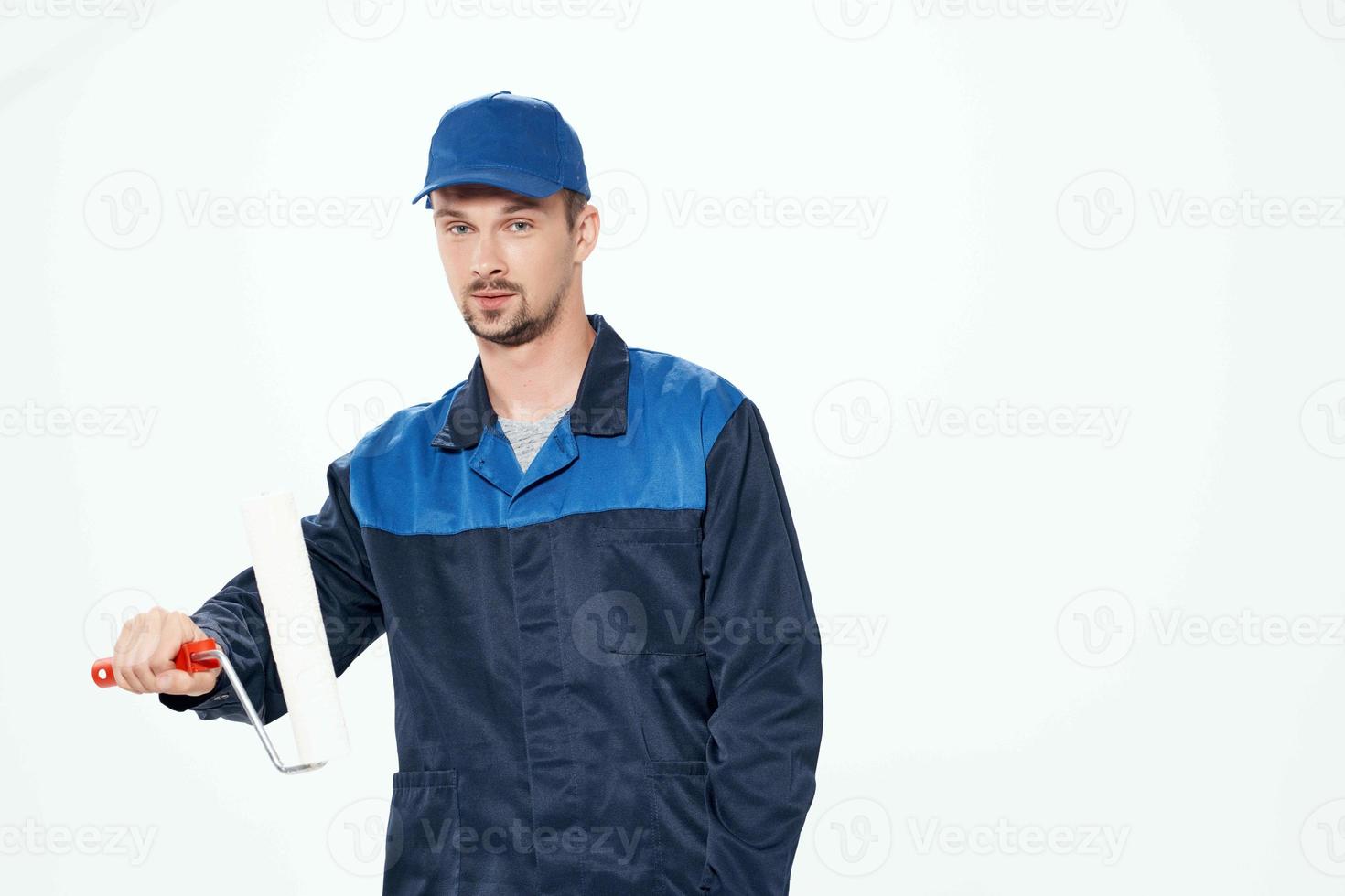 man in work uniform wall painting repair service photo