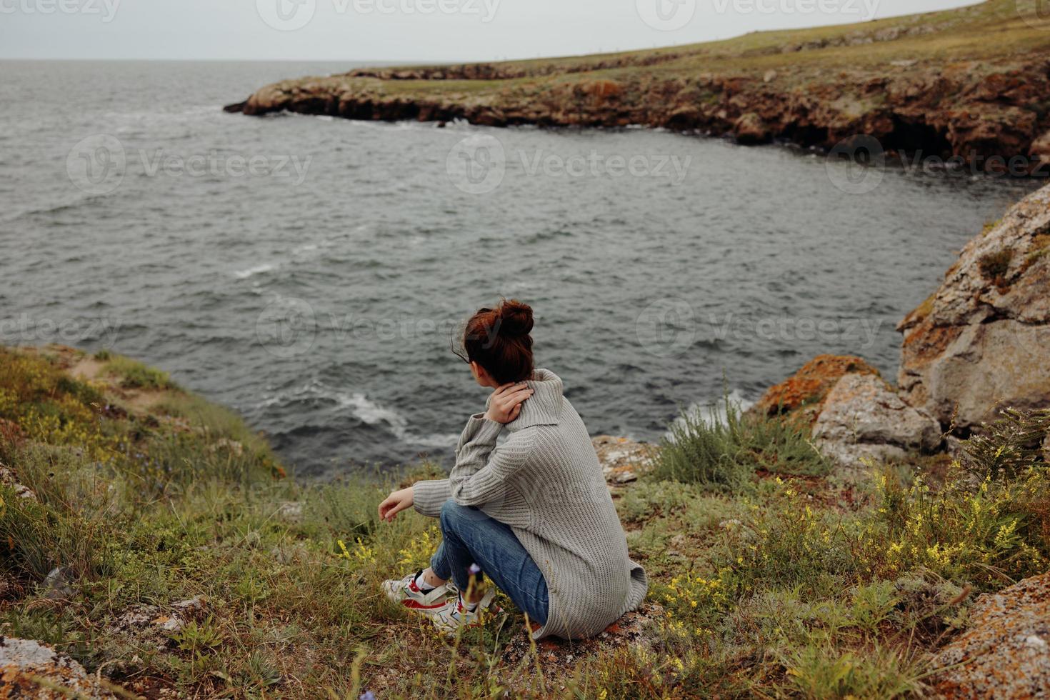 beautiful woman nature rocks coast landscape Ocean Relaxation concept photo