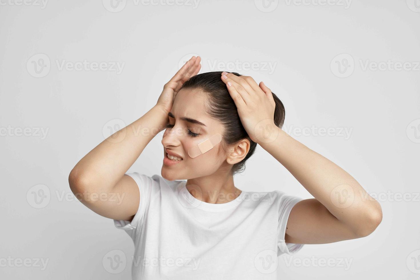 sick woman in a white t-shirt negative headache close-up photo