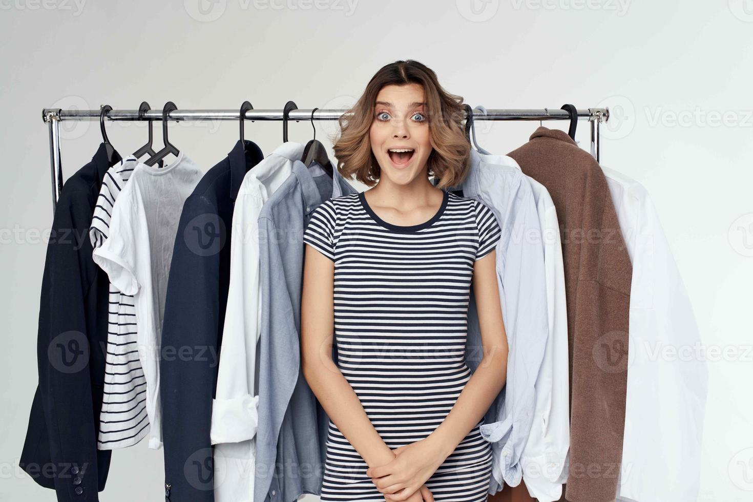 cheerful woman trying on clothes shop retail isolated background photo