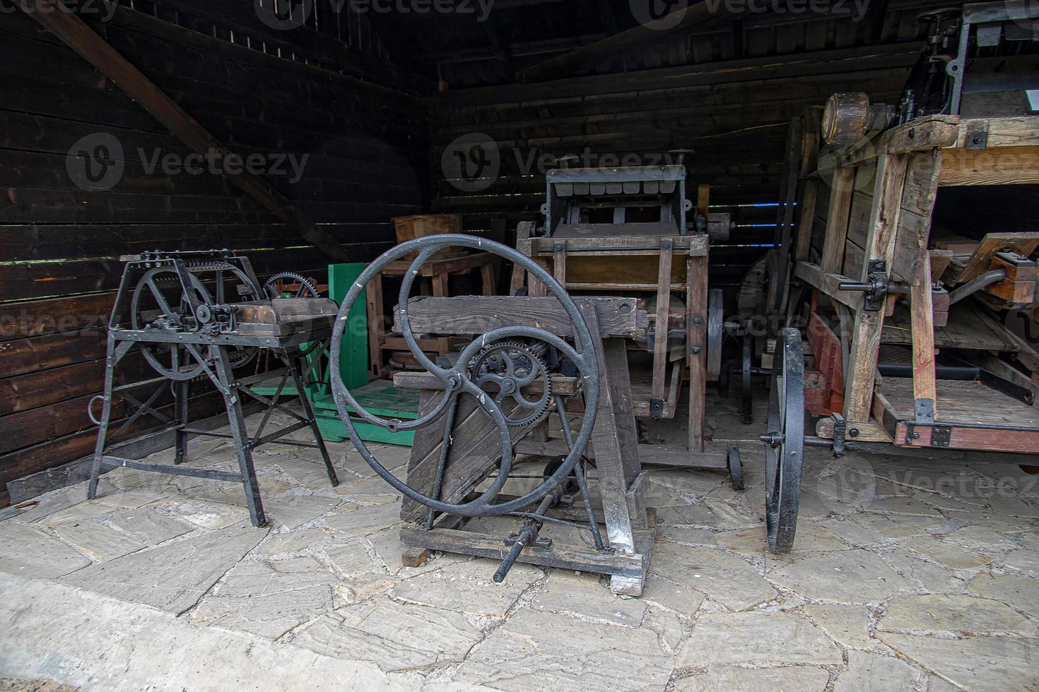 antique metal farm machinery in an open-air museum photo