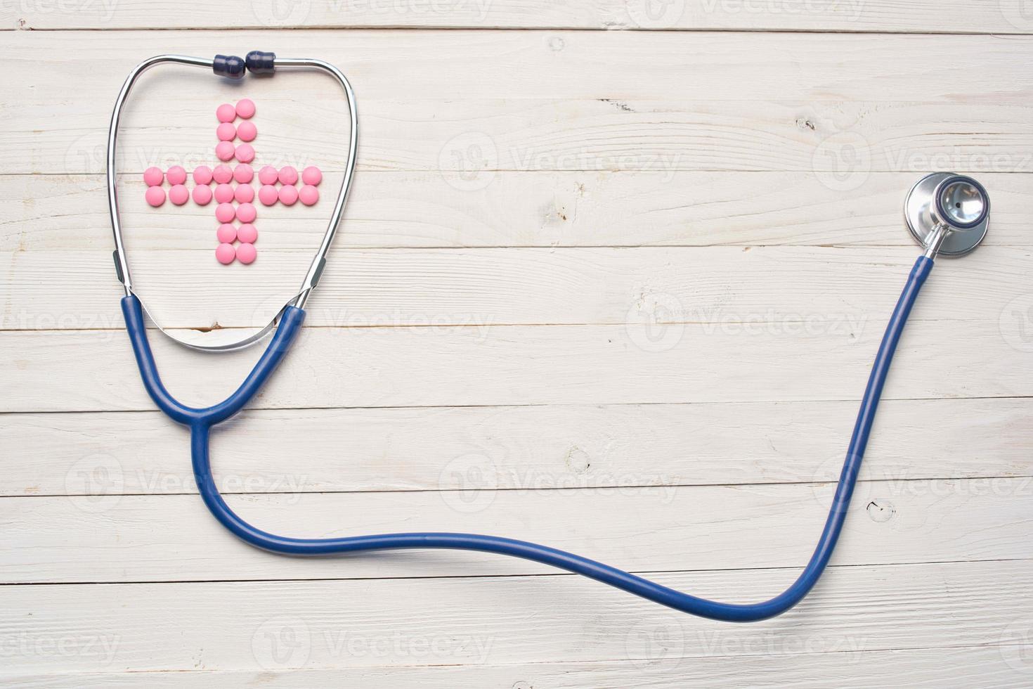 stethoscope pills medicine pharmaceutical treatment wooden background photo