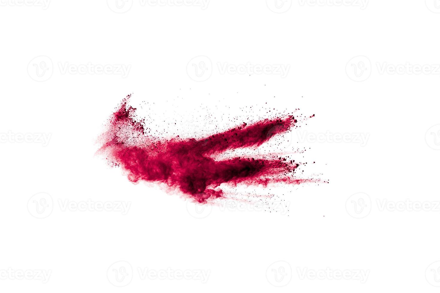 Abstract red dust explosion on white background. Freeze motion of red powder splash. photo