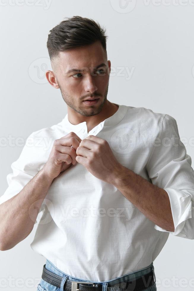 Handsome attractive serious model man guy wear linen shirt posing isolated on over white studio background. Fashion Style New Collection Sale ad concept. Copy space, banner. Model shoot photo