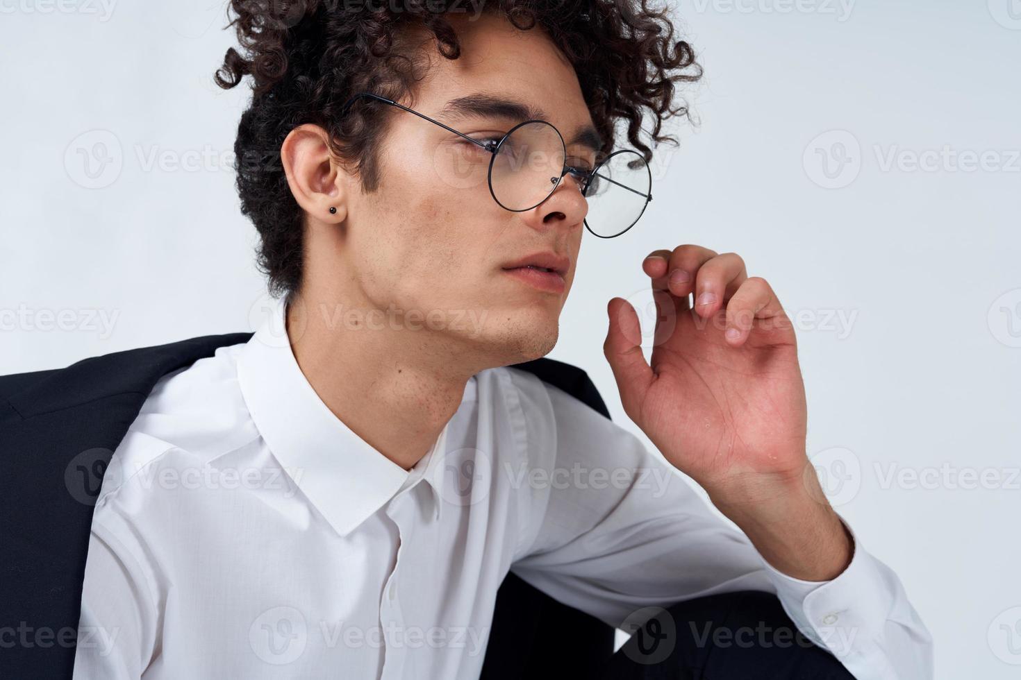 pretty guy in glasses and in a classic suit on a light background portrait close-up fashion style photo