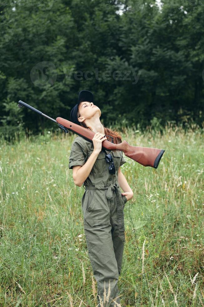 Military woman Look up shotgun fresh air nature black cap photo