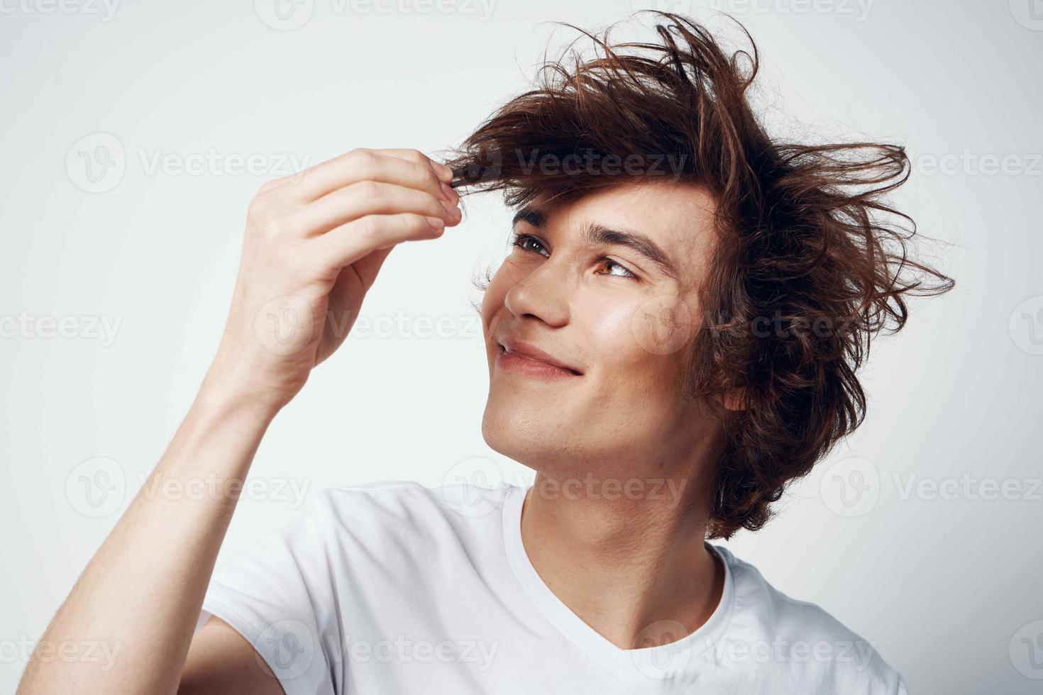 cute guy in white t-shirt tousled hair emotions posing photo