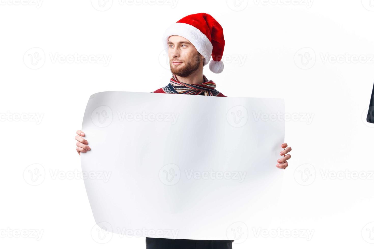 handsome man in New Year's clothes holding a banner holiday light background photo