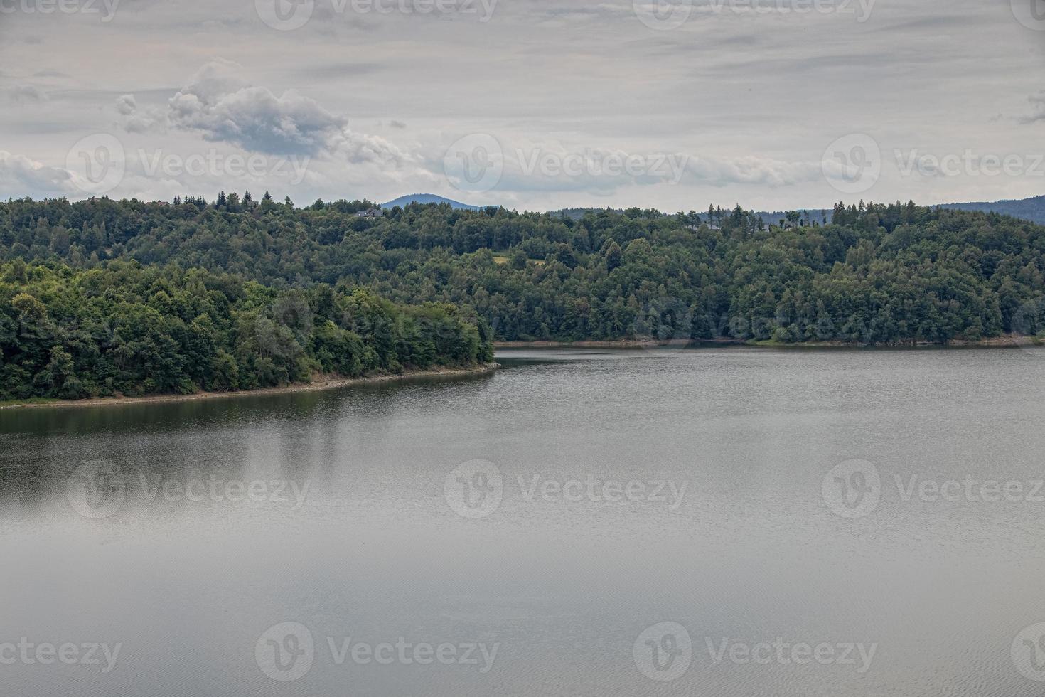 landscape of the lagoon at the dam in Dobczyce in Poland on a warm summer cloudy day photo