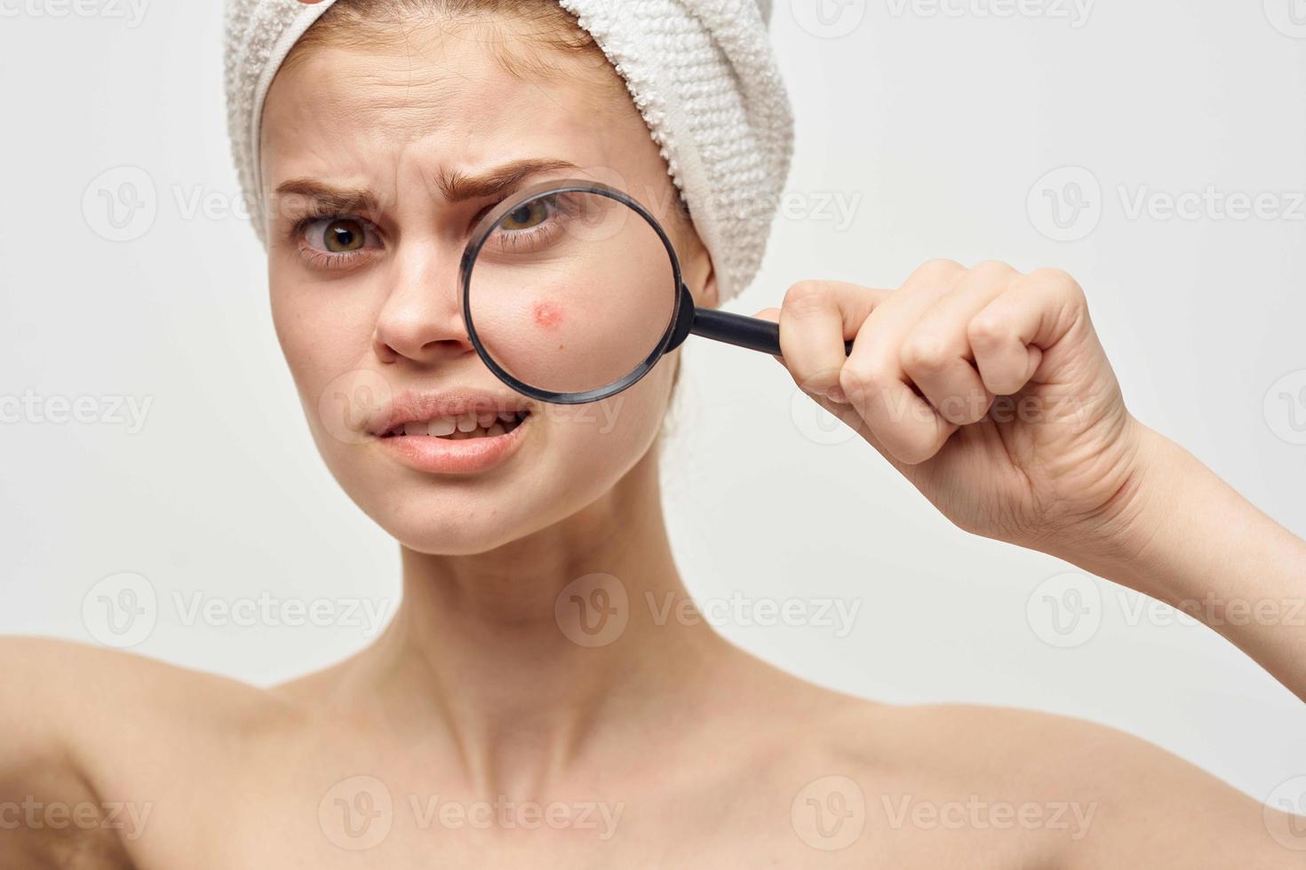 beautiful woman with a magnifying glass in hand hygiene treatment photo