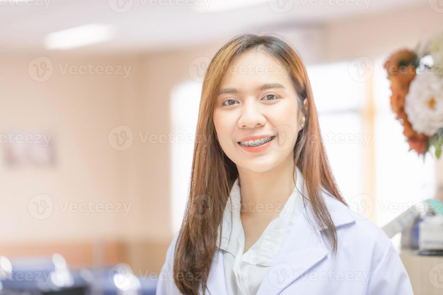 Portrait of Cheerful young female doctor posing and smiling at hospital, Medical healthcare and doctor service photo