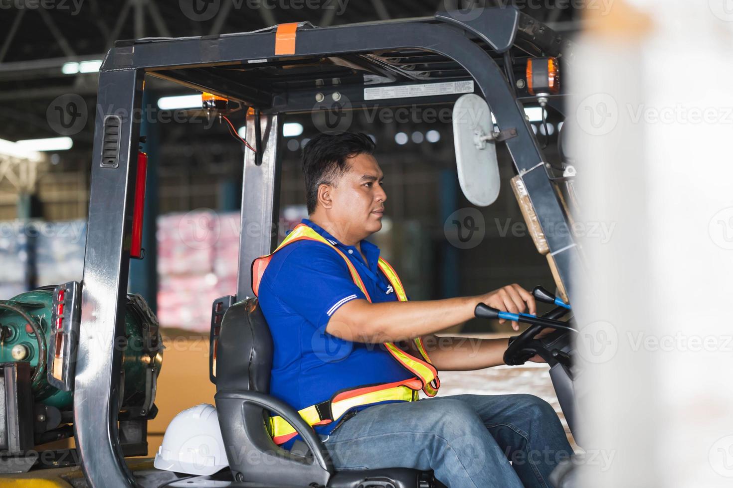 Worker on forklift, Manual workers working in warehouse, Worker driver at warehouse forklift loader works photo