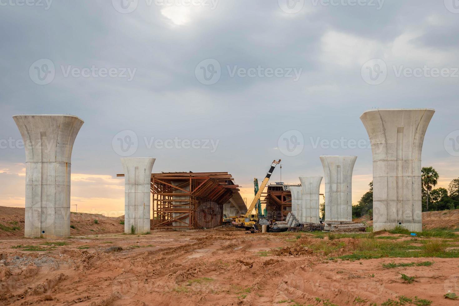 Infrastructure construct concepts, Construction of Highway line in progress with heavy infrastructure, , Bridge construction site with crane lifting prefabricated concrete framework photo