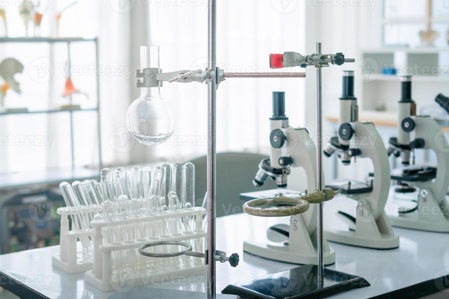 Science laboratory, Microscope and test tubes on the working table chemistry laboratory, scientist test tube with samples photo