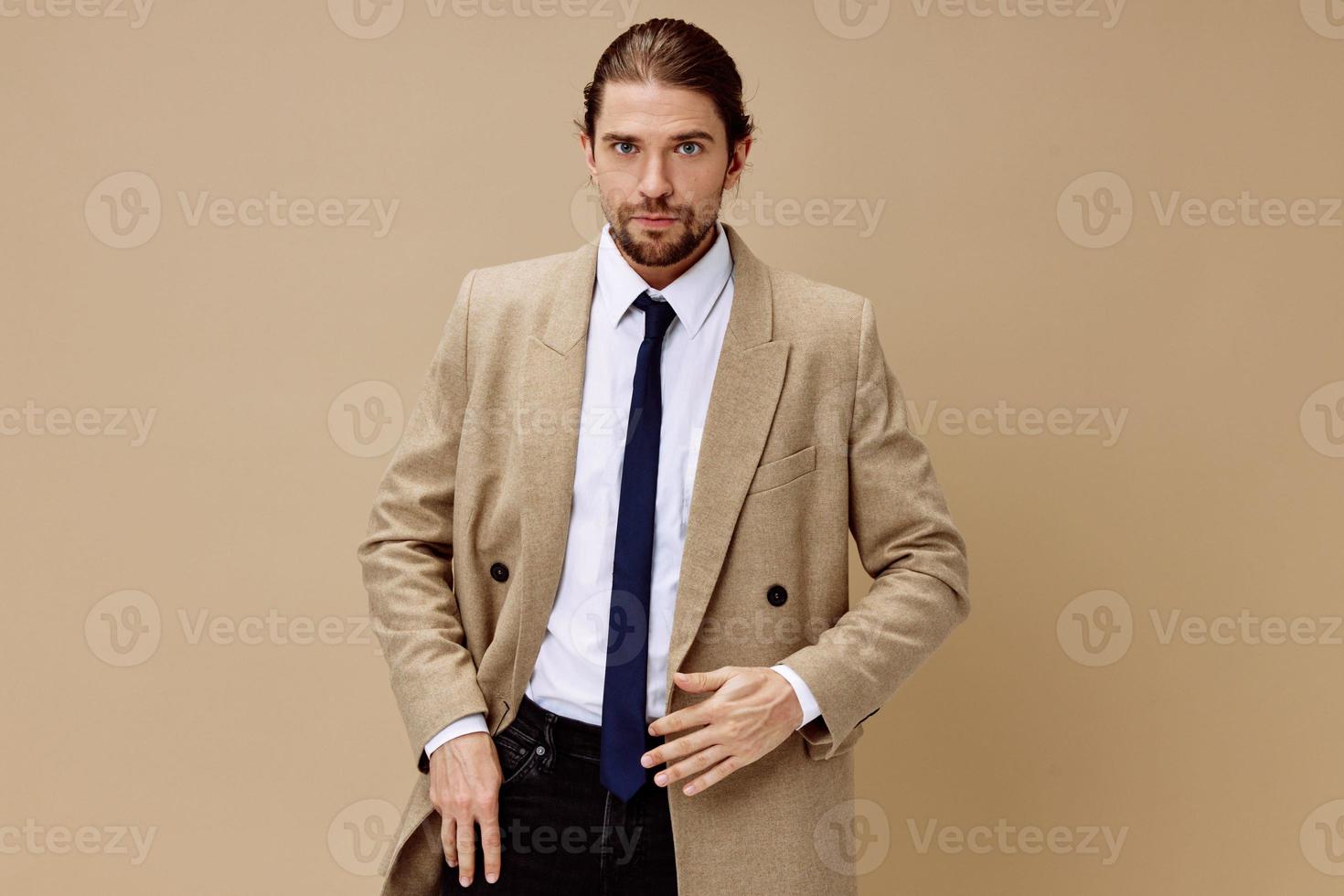 fashionable man in a suit with a tie posing isolated background photo