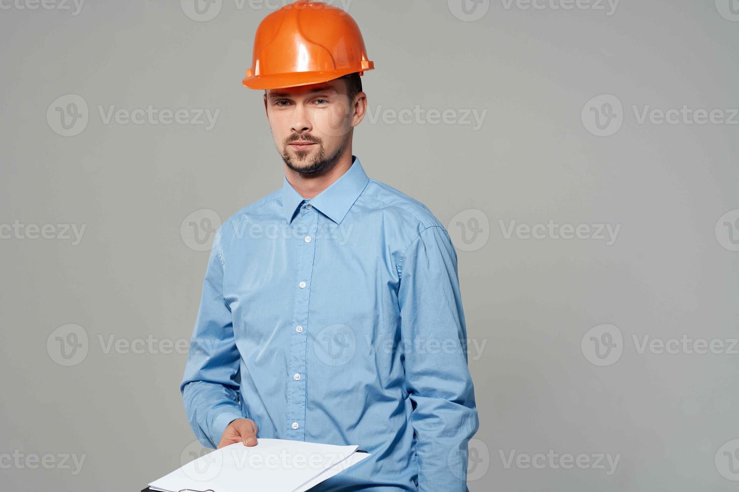 man in construction uniform blueprints builder light background photo