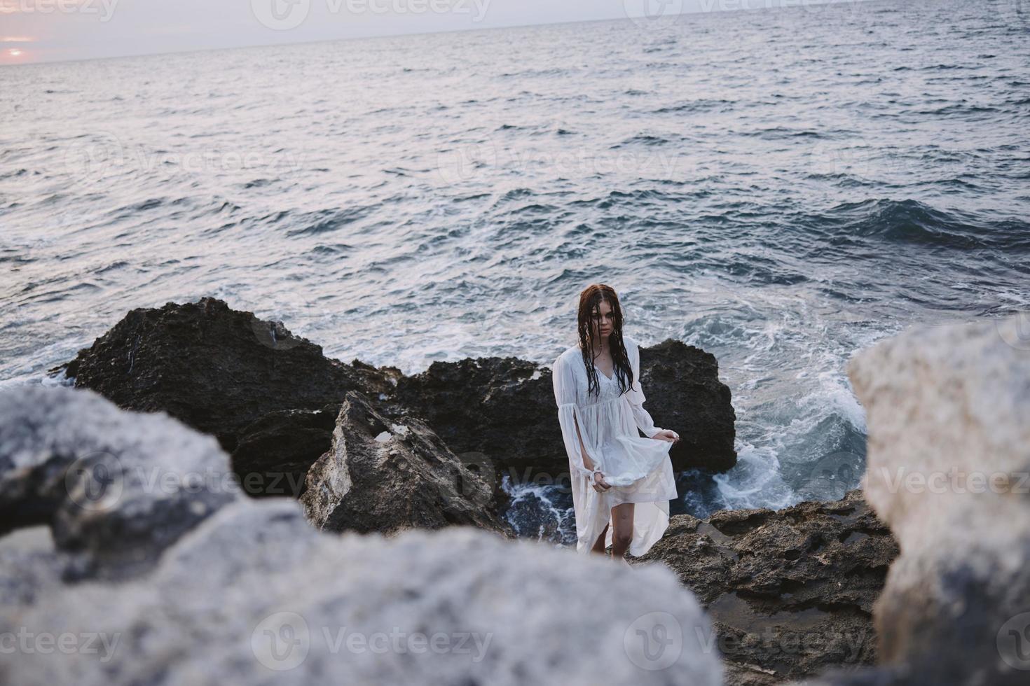 Beautiful woman walks volcanic rock formations on the island Lifestyle photo