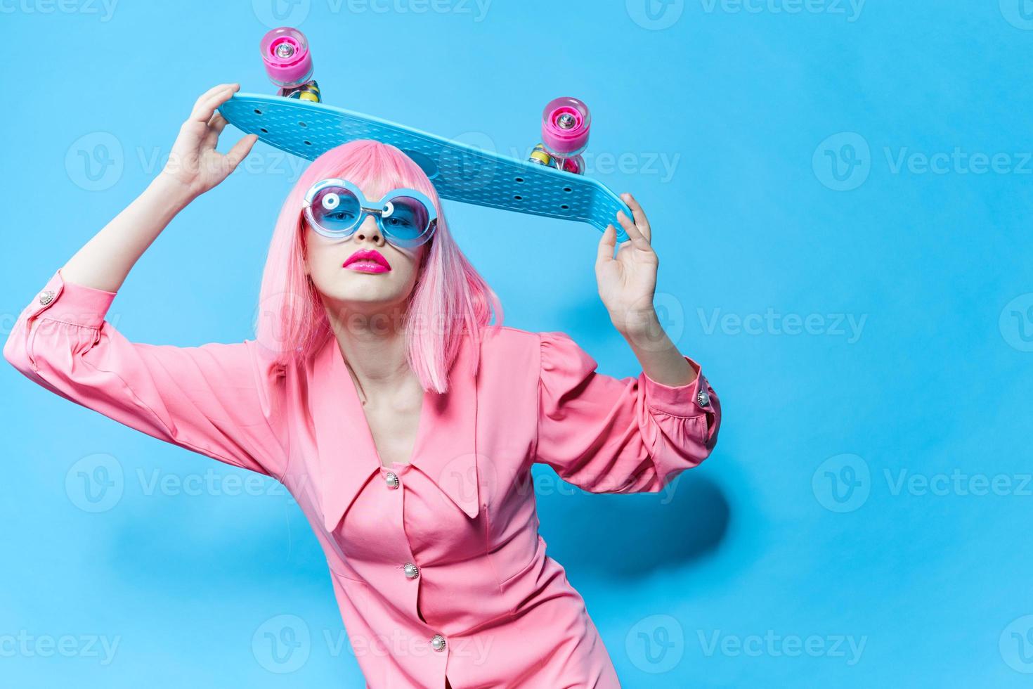 portrait of a woman in sunglasses wears a pink wig studio model unaltered photo