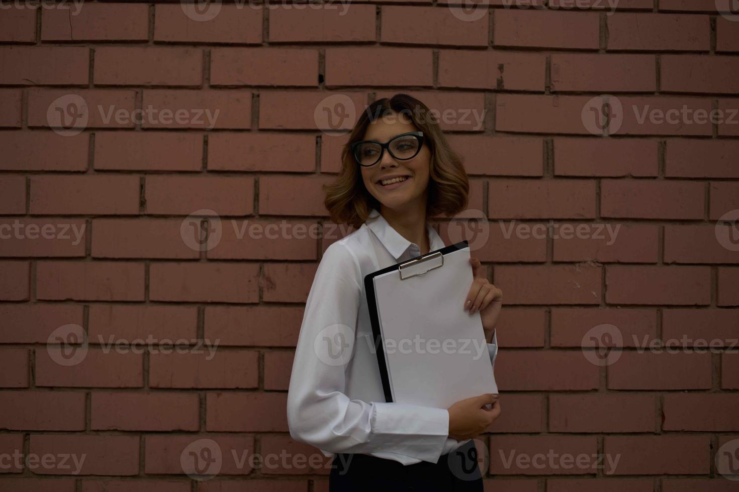 woman in white shirt documents work professional photo