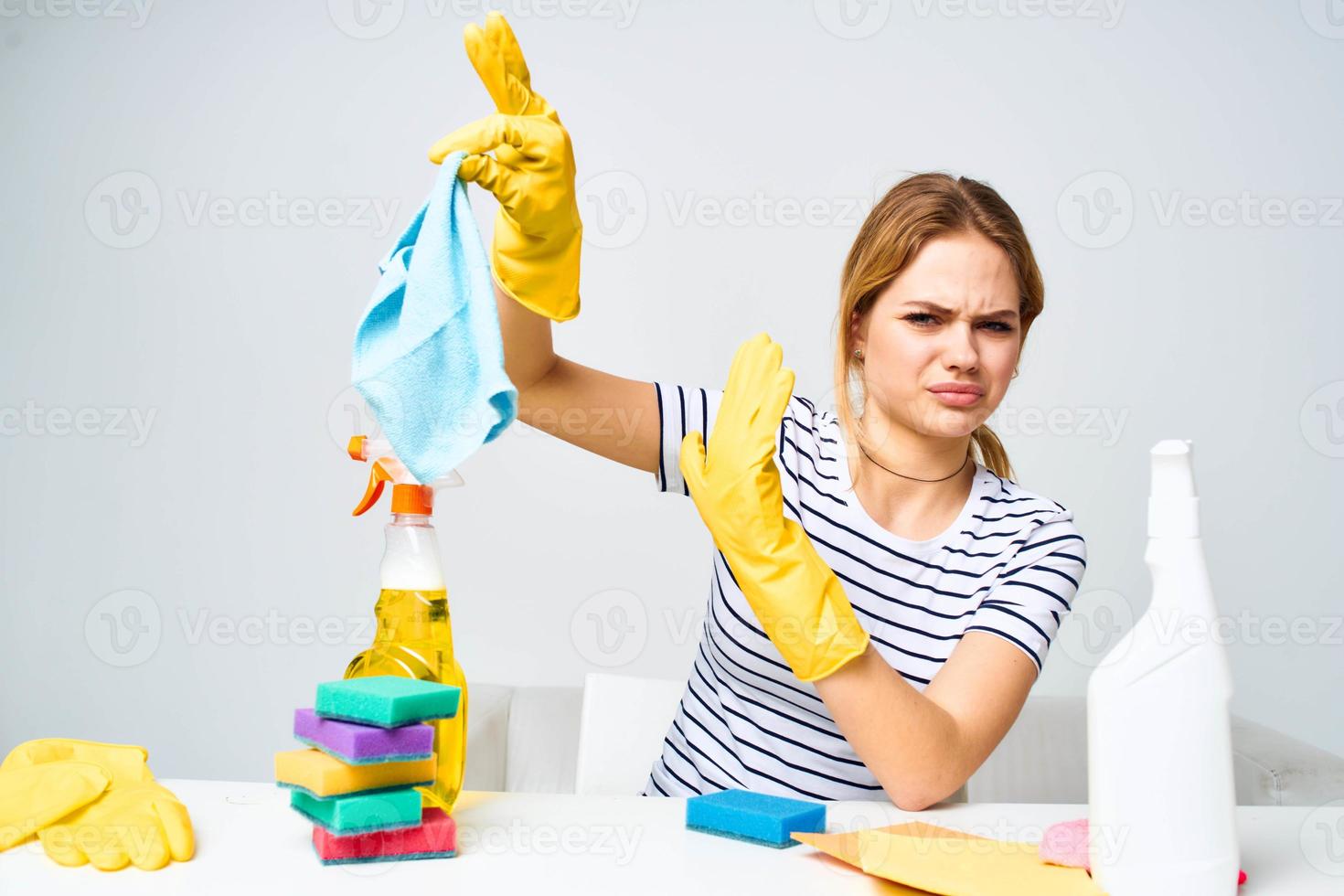 Woman holding a rag cleaning detergent supplies housework interior photo