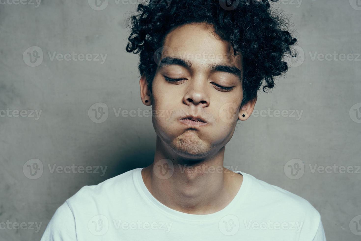 emotional man curly hair white t-shirt close up photo