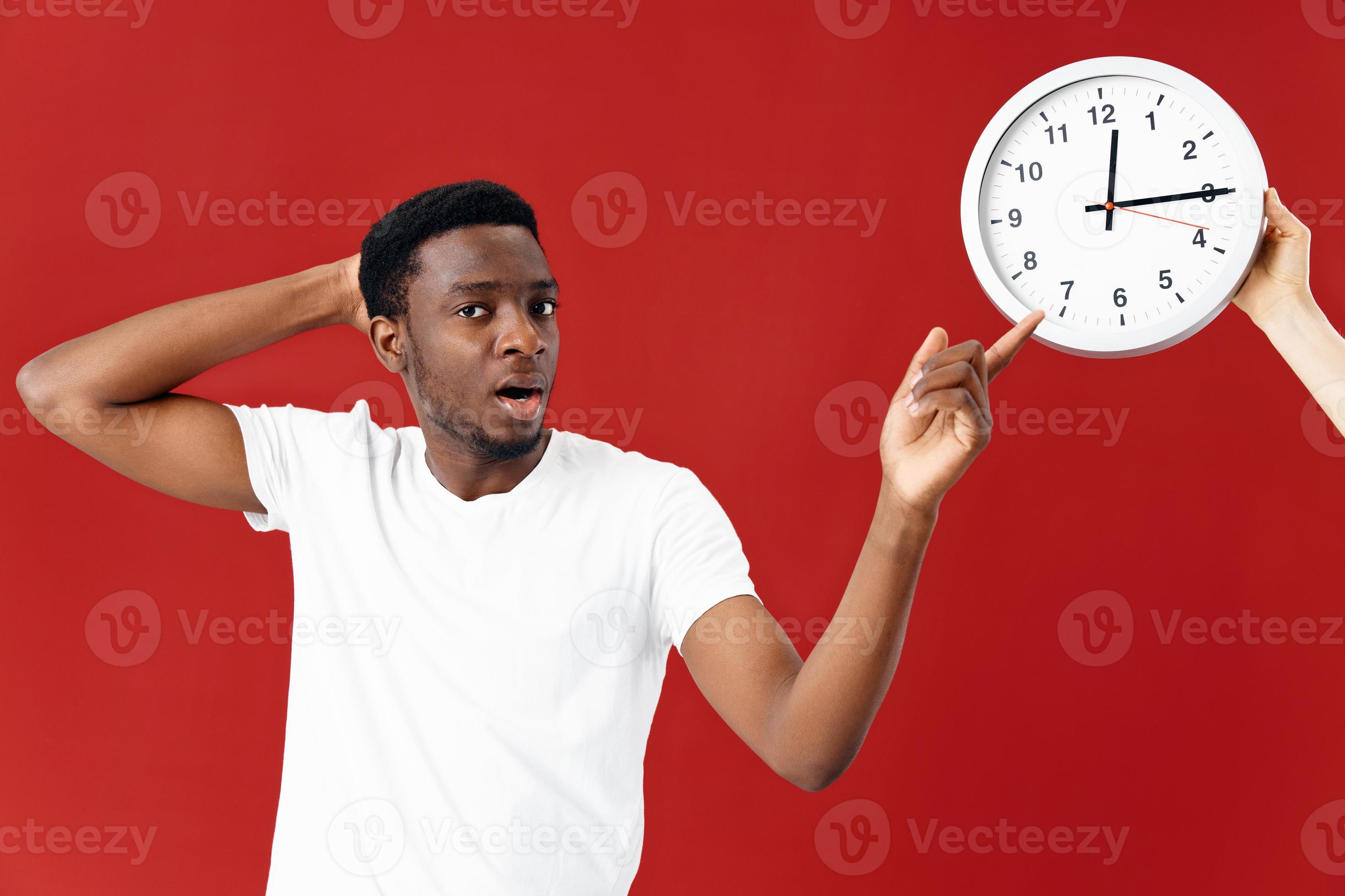 surprised man next to clock in white tshirt cropped view 22312229