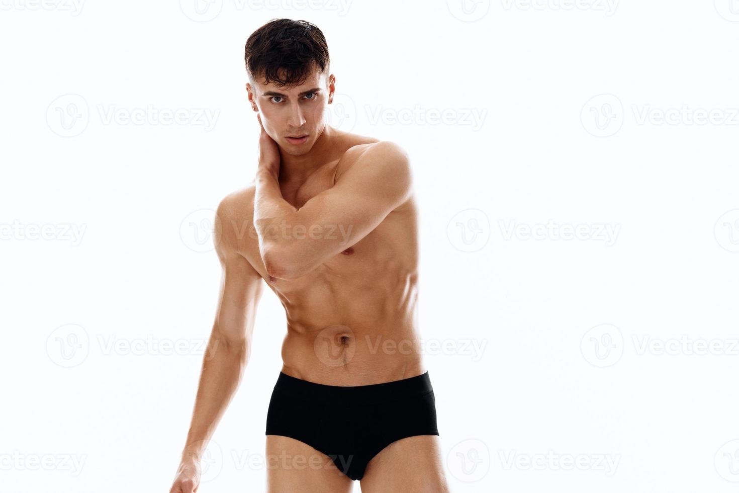 sexy man with naked muscular body posing on a light background photo