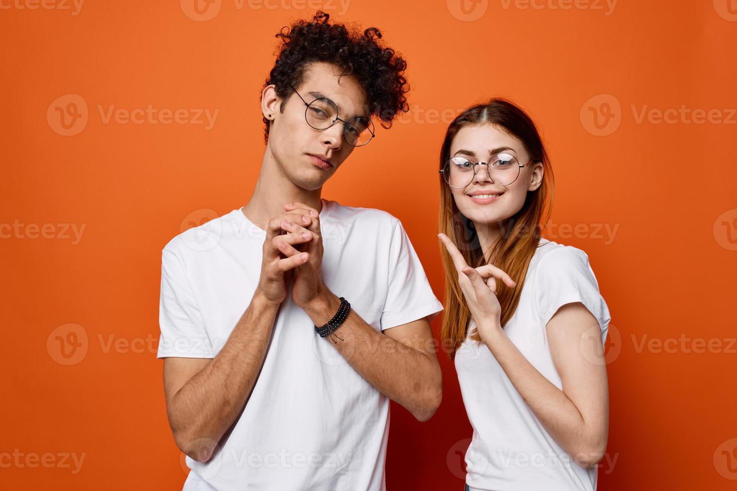 cheerful young couple wearing glasses communication isolated background photo