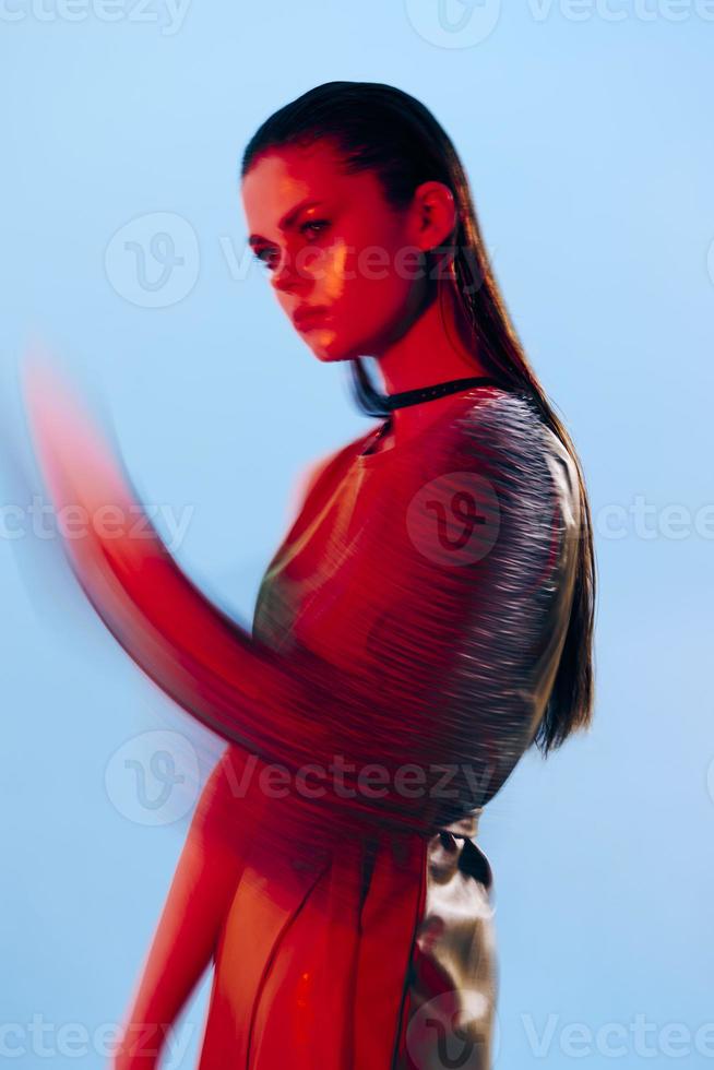 photo pretty woman Glamor posing red light metal armor on hand Lifestyle unaltered