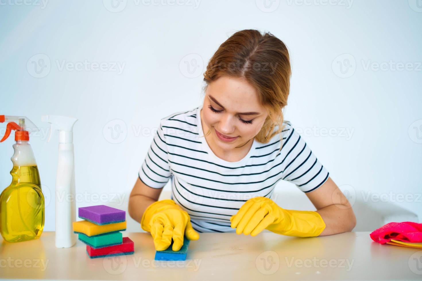 The cleaning lady sits at the table washing supplies cleaning work service photo