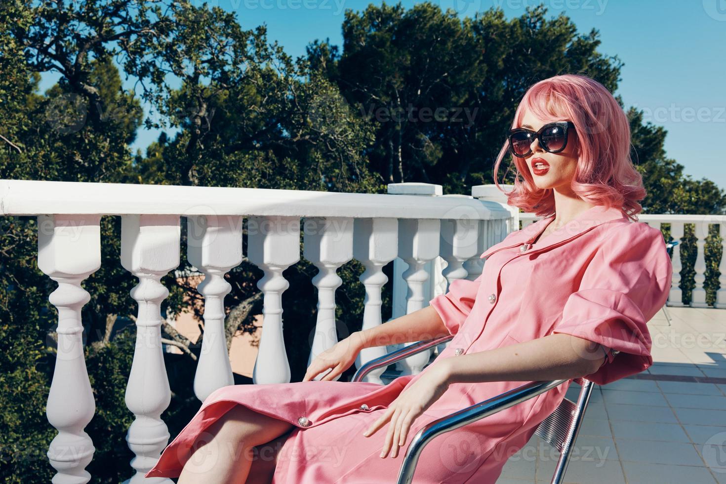 glamorous woman pink dress modern style stands near the railing Lifestyle photo